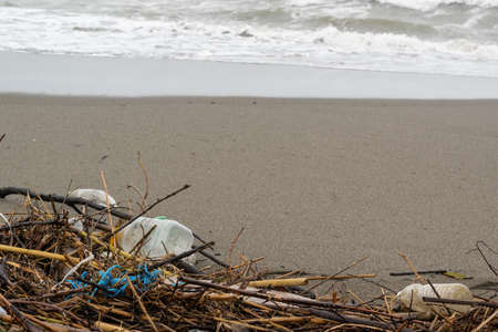Trash thrown away in the beach, environmental problems. Natural disaster conceptの写真素材