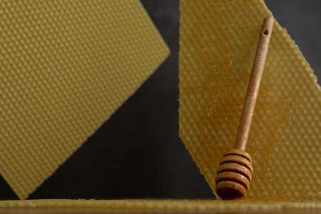Spoon with raw honey and bee comb on dark background, healthy nutrition conceptの写真素材