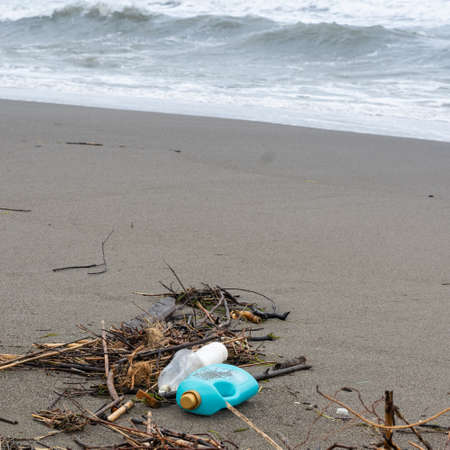 Trash thrown away in the beach, environmental problems. Natural disaster concept