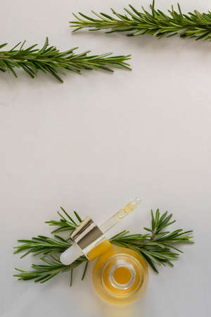 Essential oil with rosemary leaves extract. Hygiene bath product. Wellness therapy regenerationの写真素材