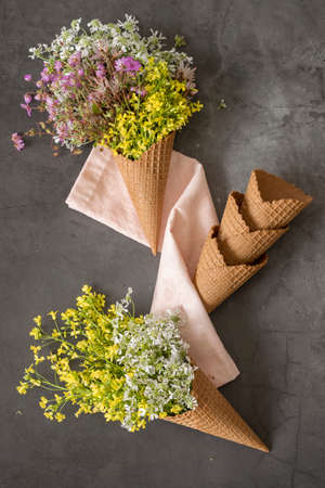 Waffle ice cream cones filled with fresh blossom wild flowersの写真素材