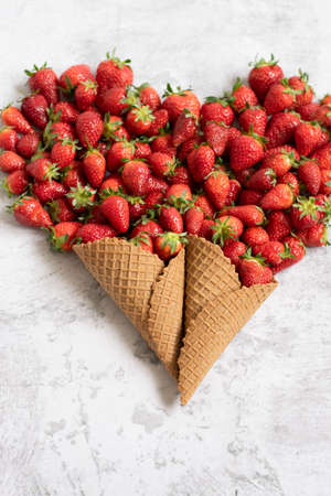 Heart shaped ice cream cones with fresh strawberriesの写真素材