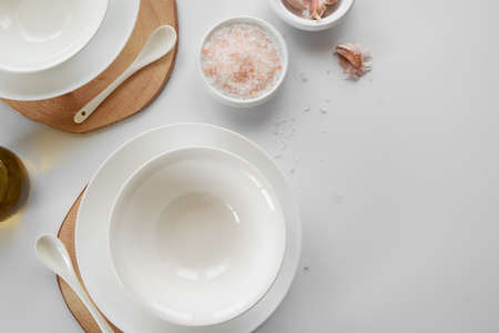 Empty white dishes on table, space for textの写真素材