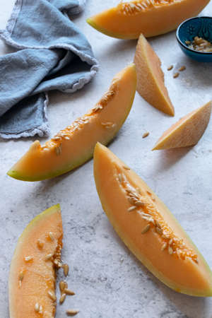 Fresh melon sliced on table, raw ripe biological fruit, food backgroundの写真素材