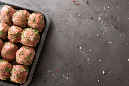 Fresh raw meatballs, minced beef meat on black background