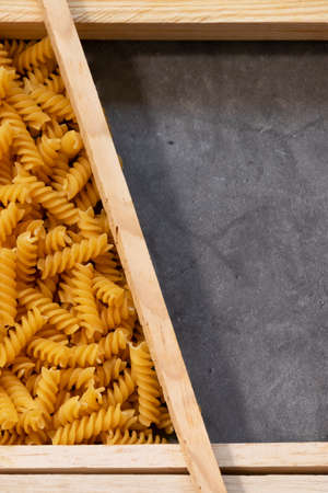 Raw pasta in asymmetrical boxes, space for textの写真素材