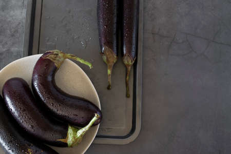 Raw purple aubergine on dark backgroundの写真素材