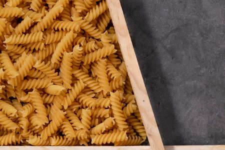 Raw pasta in asymmetrical boxes, space for textの写真素材