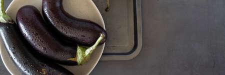 Raw purple aubergine on dark backgroundの写真素材