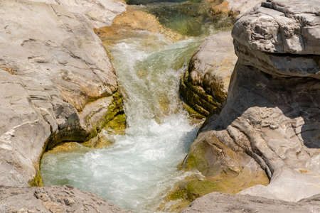 Quiet turquoise river stream along the tectonic rocksの写真素材