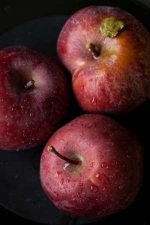 Close up of three red apples. Dark mood food photography