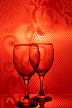 Empty glasses on the table with colorful gradient backlight illuminationの写真素材
