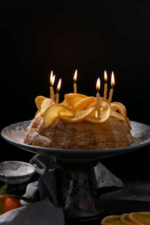 Traditional homemade orange cake, dark background, food themesの写真素材