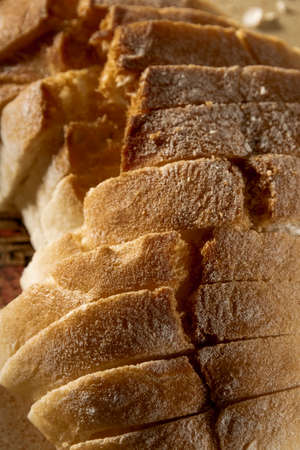 Close up view of sliced white bread on rustic wooden table