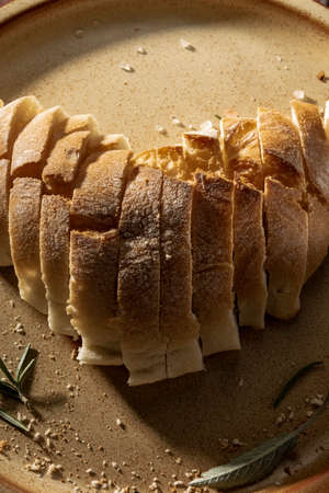 Close up view of sliced white bread in heart shape on rustic wooden tableの写真素材