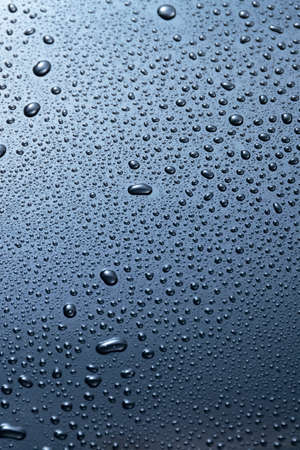 Abstract blue water drops on dark  surface