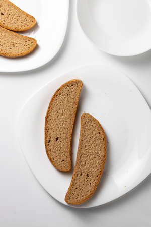Slices of wholemeal bread in empty plates, dieting, poverty concept