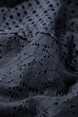 Fashionable black cloth, ondulate modern textile close up view