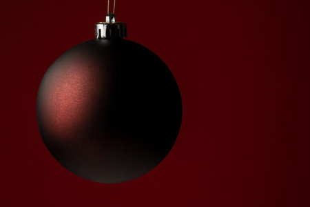 Christmas minimal decor background, royal red color background with single white ball decoration, vertical view with space for textの写真素材