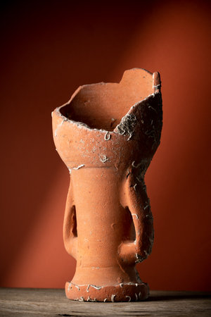Old broken terracotta vase, handmade antique objectの写真素材