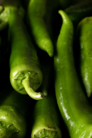 Fresh raw green peppers on table, genuine food ingredients, agricultural conceptの写真素材