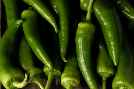 Fresh raw green peppers on table, genuine food ingredients, agricultural conceptの写真素材