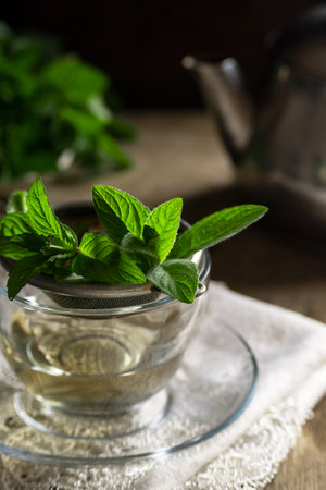 Table with mint and herbal tea, hot drink themesの写真素材