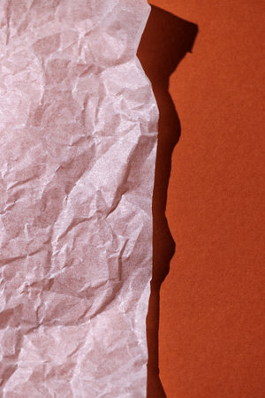 Warm orange background with a white empty sheet of paper. Top view, cozy minimal style in warm colors, space for text.の写真素材