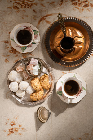 Turkish coffee with traditional sweets on antique carpetの写真素材