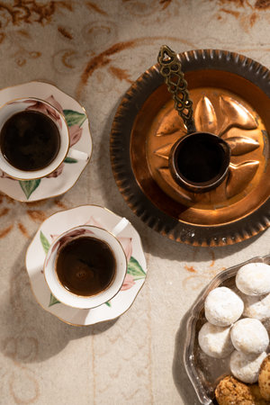Turkish coffee with traditional sweets on antique carpetの写真素材