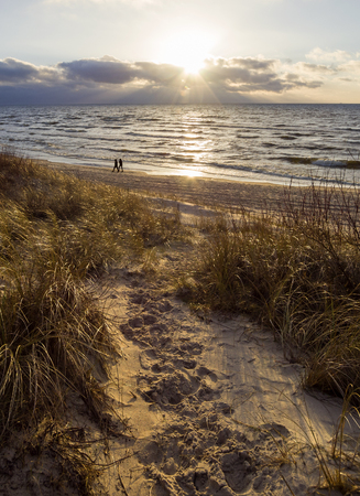Beautiful sunset on the sandy beach and dunes of the Baltic Sea in Lithuania, Klaipedaの写真素材