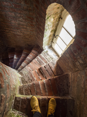 Old steps down from the red brick of the old lighthouse in Lithuania, Klaipedaの写真素材