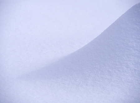 Snowdrift and snow texture on a bright sunny dayの写真素材