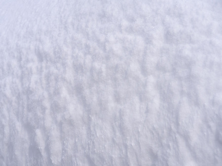 Snowdrift and snow texture on a bright sunny dayの写真素材