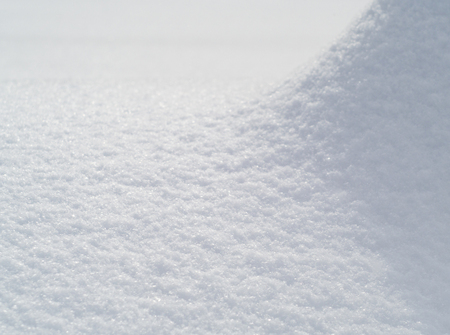 Snowdrift and snow texture on a bright sunny dayの写真素材