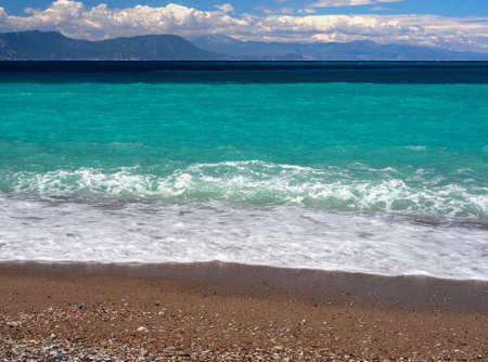 Beautiful foamy waves on the beach Psatha in the Corinthian Gulf and the Ionian sea in Greeceの写真素材