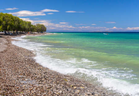 Beautiful foamy waves on the beach Psatha in the Corinthian Gulf and the Ionian sea in Greeceの写真素材