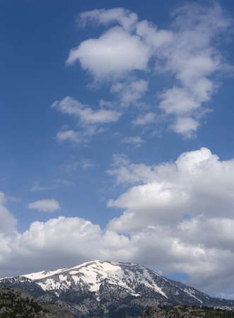 Panoramic view of snow covered mountain Dirfys and sky with clouds on on the island of Evia, Greece