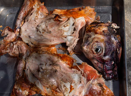 Easter lamb with its head chopped into large chunks, baked on a spit in a village in Greeceの写真素材