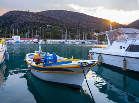 Fishing boats stand in the marina of the resort town of Methana in the Peloponnese in Greeceの写真素材