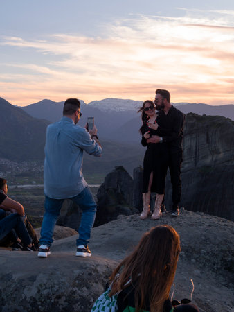 Kalabaka, Greece. April 2022: Tourists and Panoramic view of the Meteora Mountains and the Rusanou Monastery from the observation deck in Greeceのeditorial素材