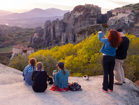 Kalabaka, Greece. April 2022: Tourists and Panoramic view of the Meteora Mountains and the Rusanou Monastery from the observation deck in Greeceのeditorial素材