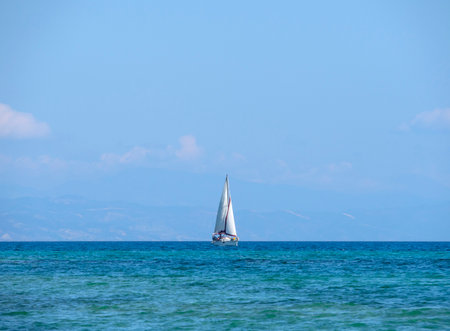 Sailing boat in the sea on a background of blue sky.の写真素材