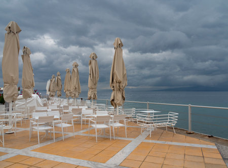 White chairs and umbrellas on the deckの写真素材