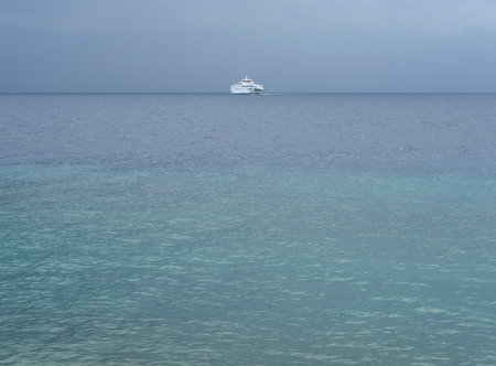 White cruise ship in the turquoise water of the Mediterranean Seaの写真素材