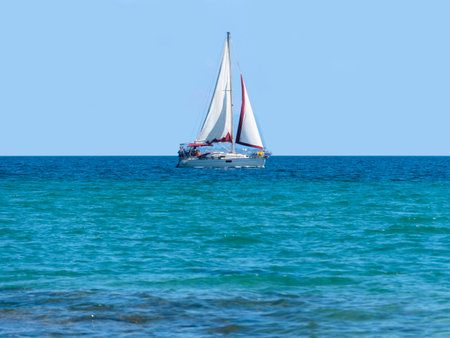 Sailboat on the azure sea with blue sky background.の写真素材