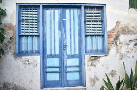Green door and a couple of windowsの写真素材