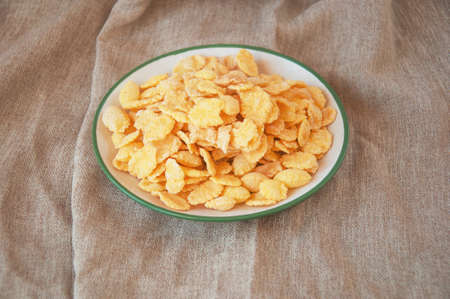 cornflakes in a bowl on textile backgroundの写真素材