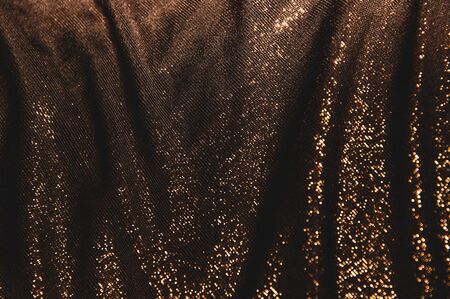 the background dark shiny brown with orange fabric