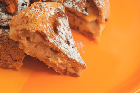 the sweet apple cake on orange plate cutの写真素材